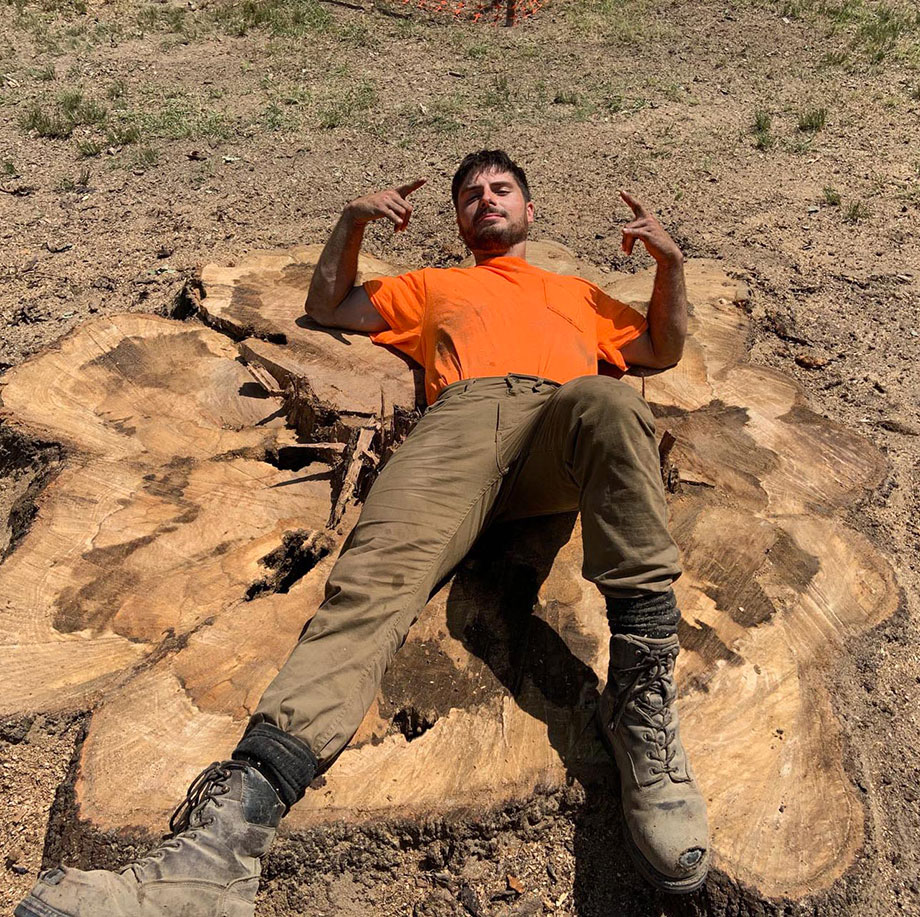 Man lying on a huge tree stump in richmond virginia